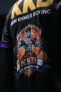Close-up of the official KKB Kun Khmer fighter artwork printed on the black jersey